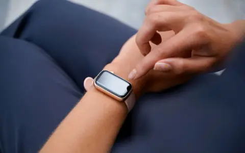 Dłoń próbuje obudzić smartwatch, który nie reaguje na ruch.